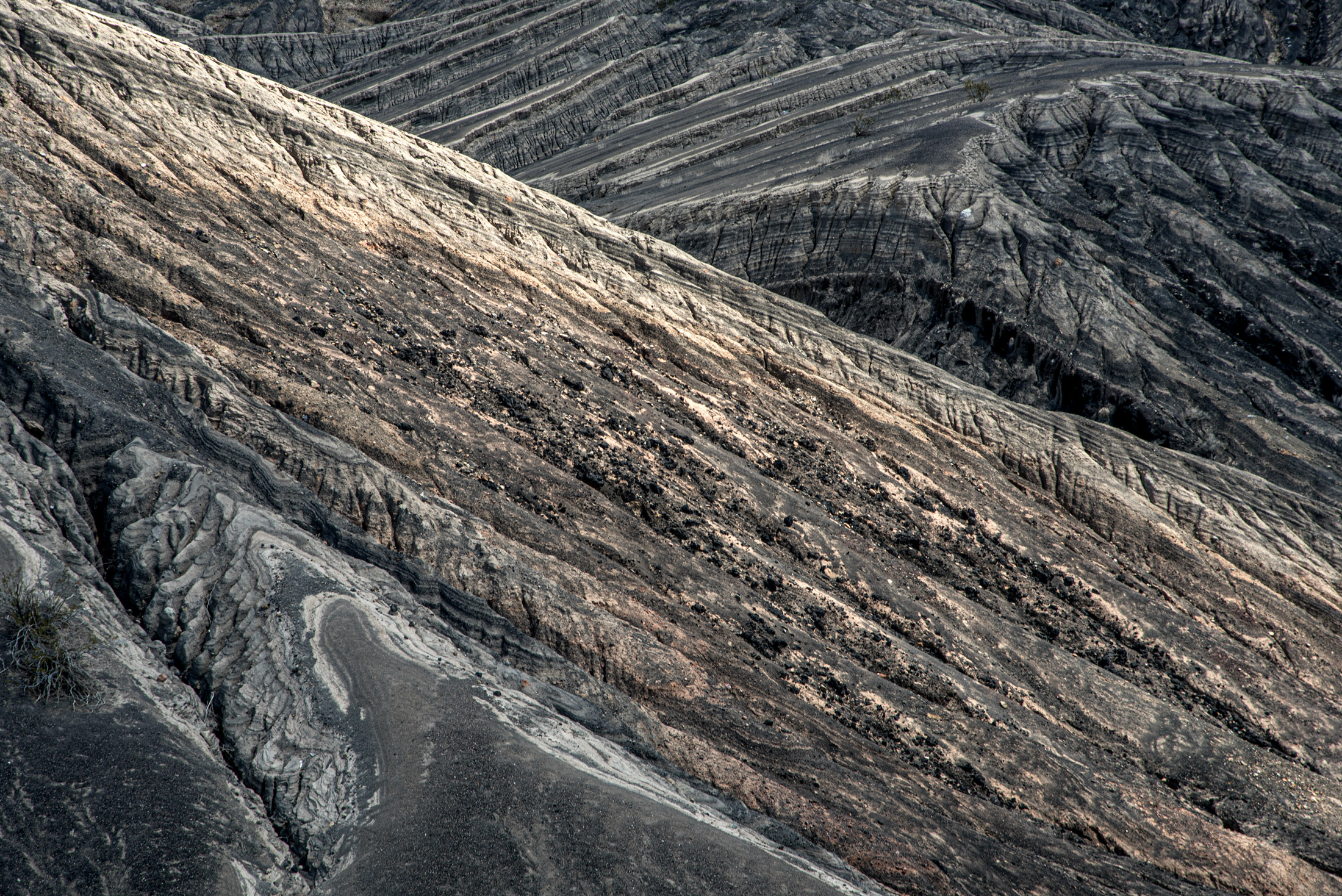 Ubehebe Crater — Rain-carved ridges cut long diagonals through the walls of Ubehebe Crater in Death Valley