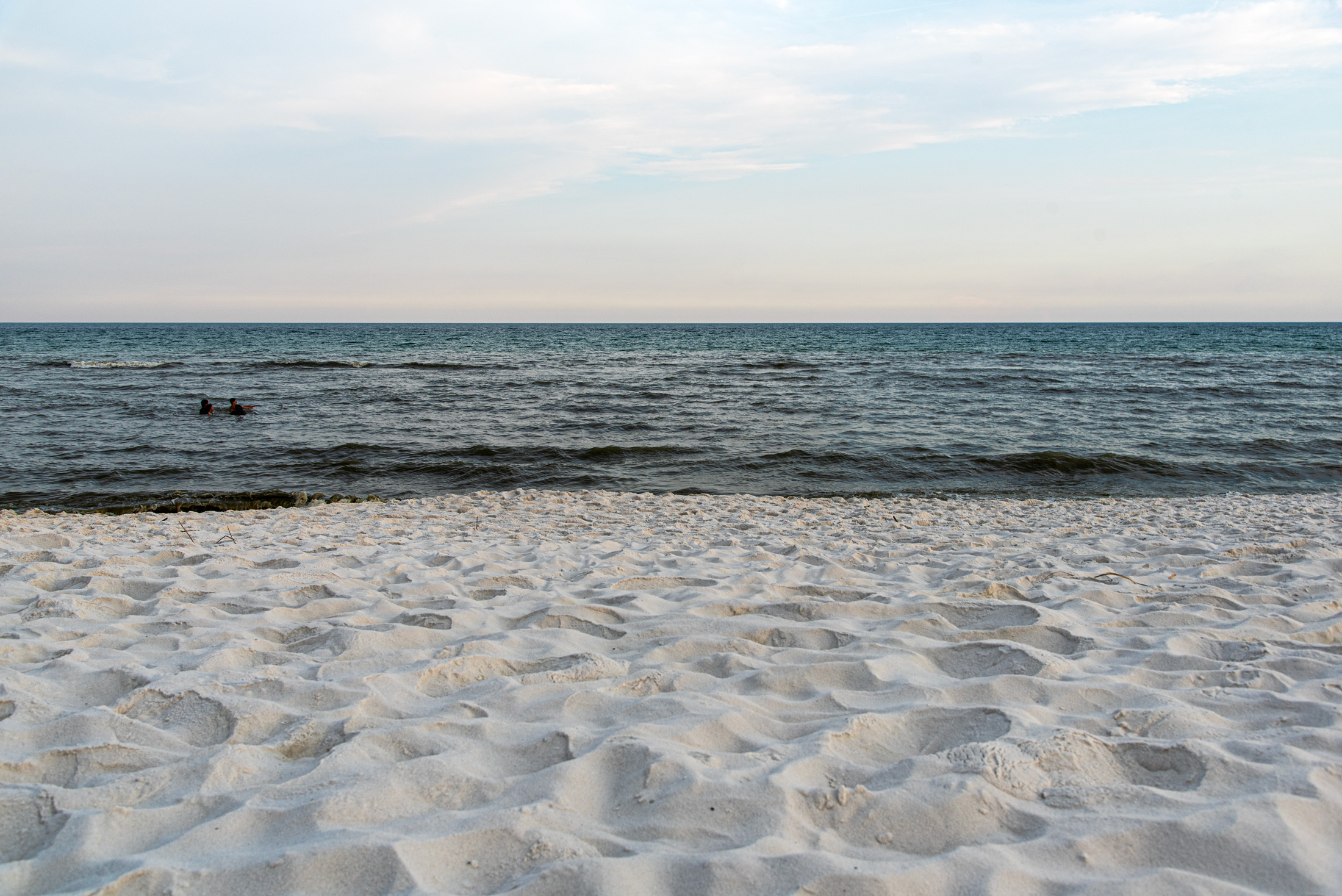 Evening Along the Gulf — The calm waters and bright white sands of Destin Beach come together beneath a soft evening sky in Florida.