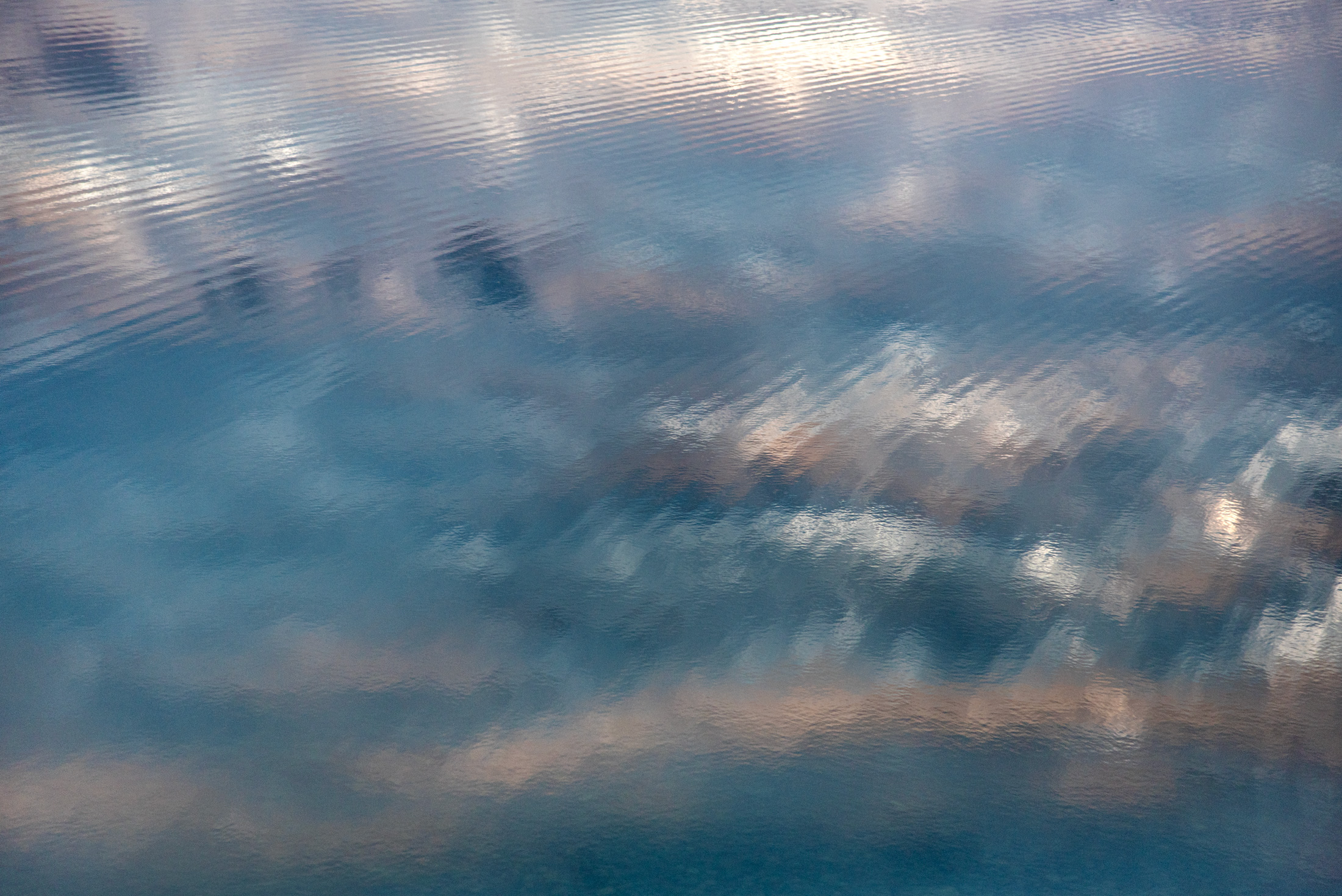 Soft Echoes of the Sky — Clouds reflect off the waters of Grand Teton National Park, creating a peaceful study of light, color, and texture.