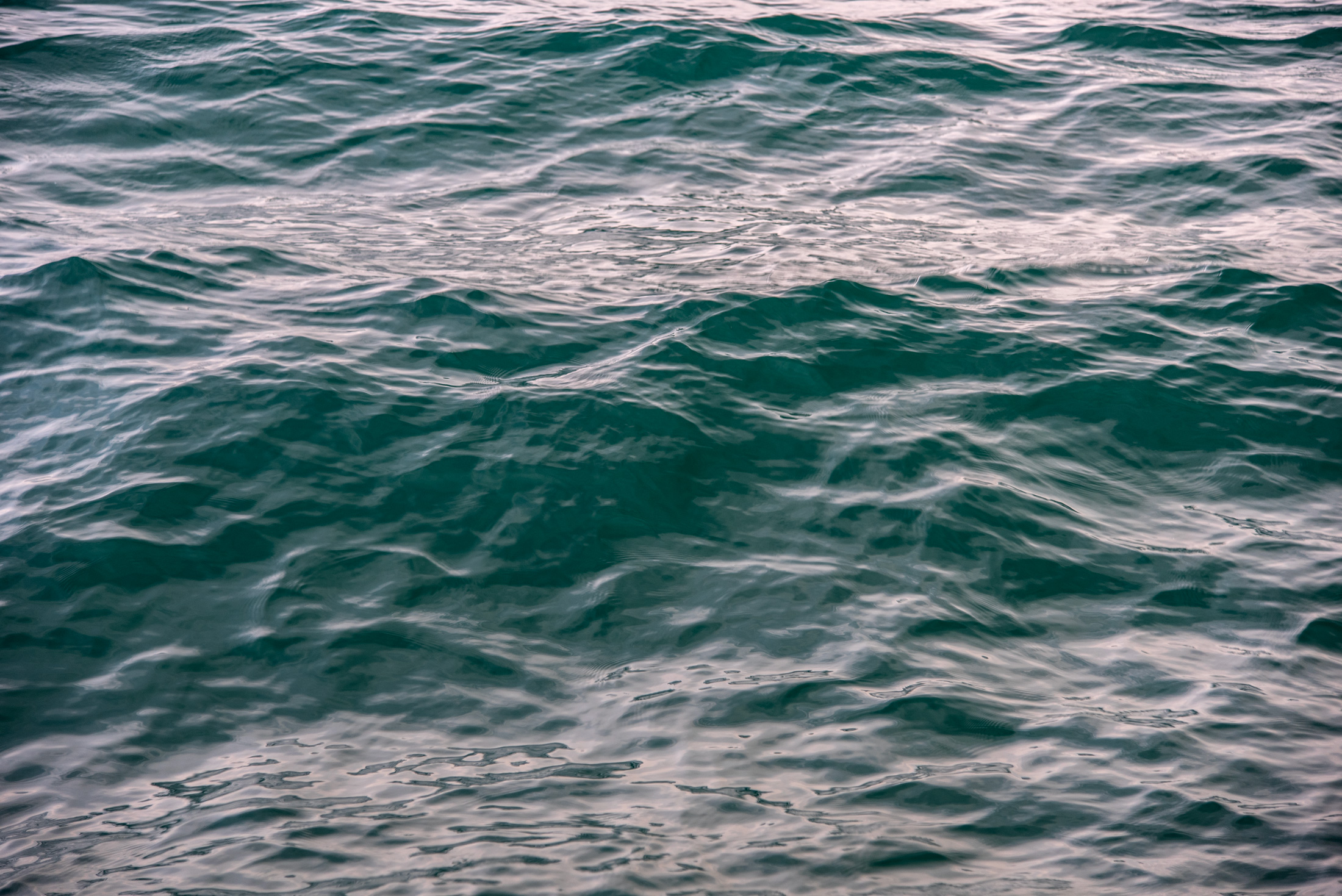 Emerald Currents — The ever-changing surface of Lake Michigan reflects subtle light and color, inviting a moment of reflection.