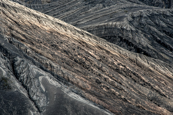 Ubehebe Crater — Rain-carved ridges cut long diagonals through the walls of Ubehebe Crater in Death Valley