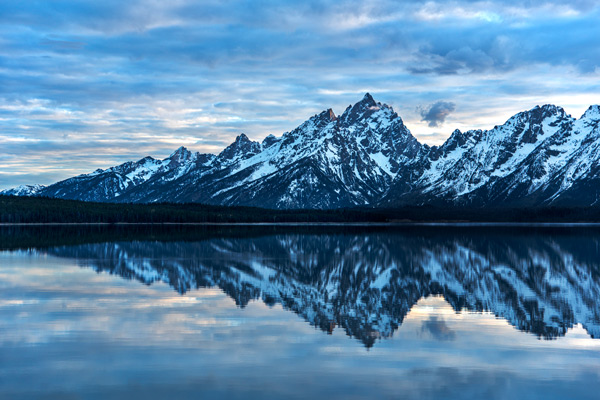 Teton Arrowhead — Snowbound Teton peaks and their mirror image meet in a perfect point on Jackson Lake